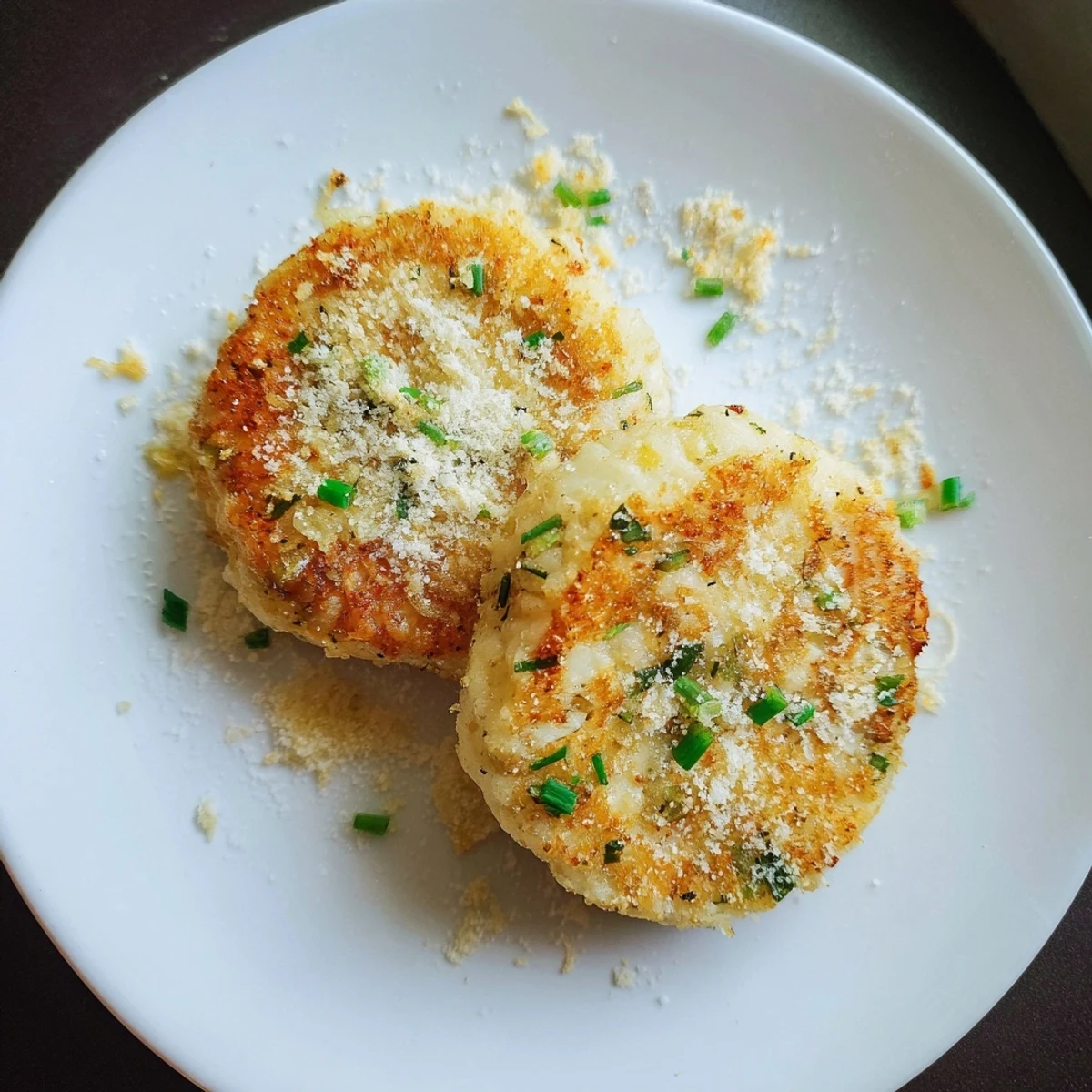 Golden-brown Simple Garlic Mashed Potato Cakes, crispy edges, ready for a satisfying, savory bite.