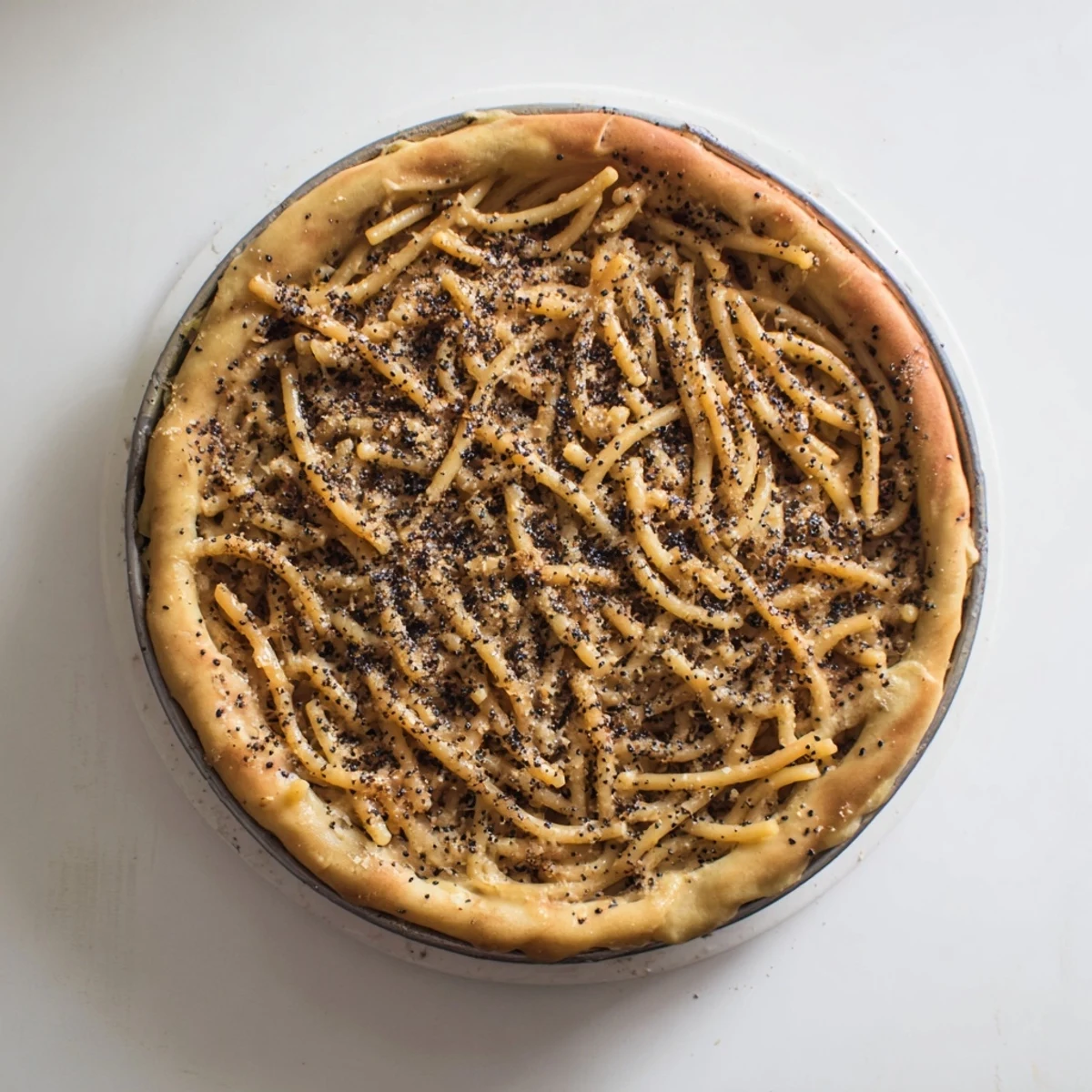 Golden-crusted Cacio e Pepe Pasta Pie, showing a warm, cheesy interior, ready to serve and enjoy.