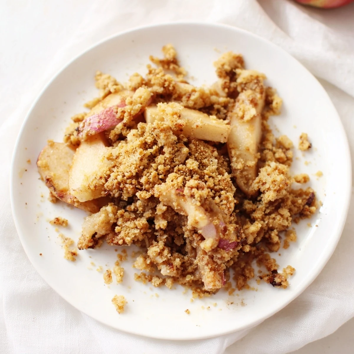 A warm, freshly baked cinnamon oat apple crisp with a golden, bubbly oat topping.