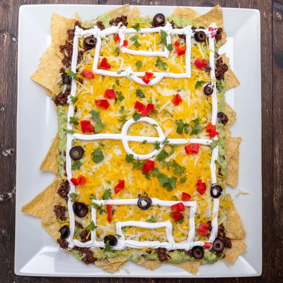 A vibrant, game-day Soccer Field Nacho Platter boasts melted cheese and tasty toppings.