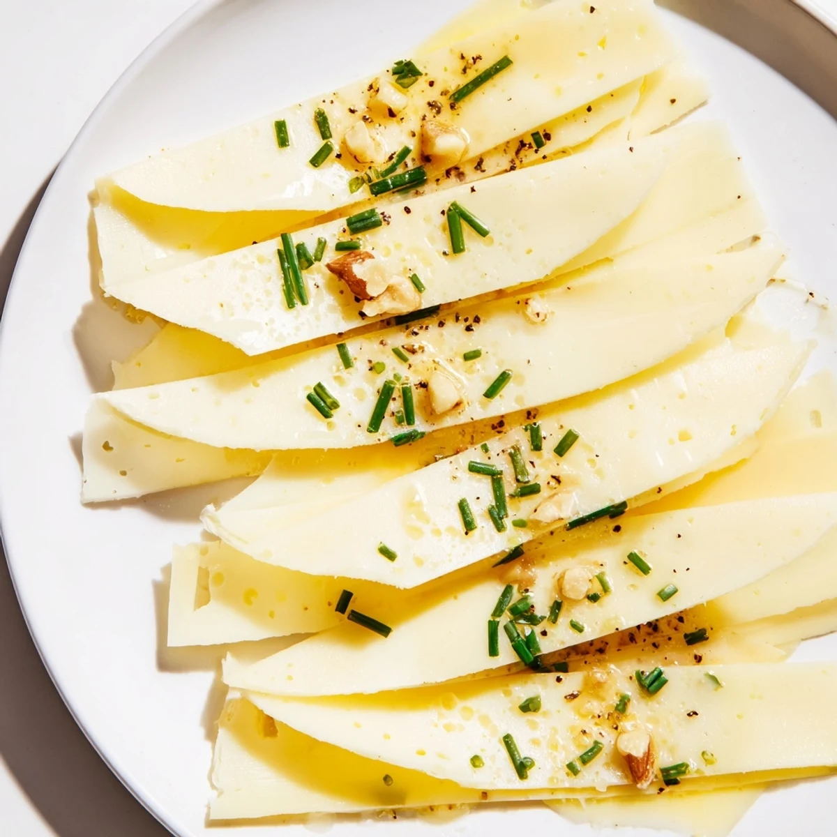 Artfully arranged Swiss cheese slices layered in a fan, ready for a delicious appetizer.