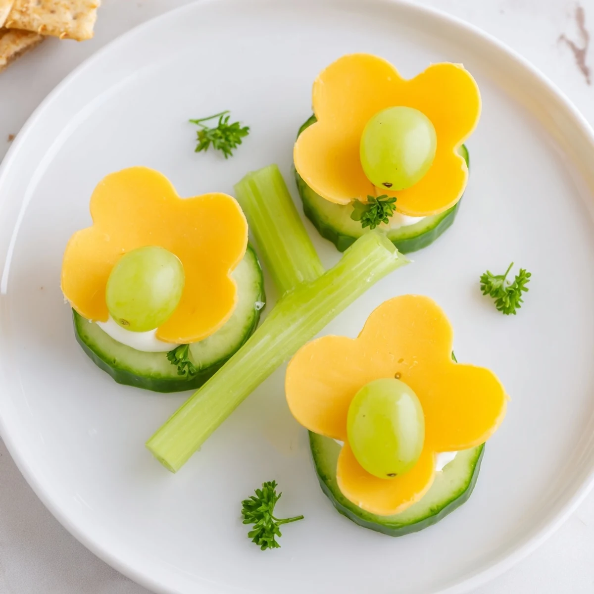 Vibrant Lucky Four-Leaf Clover Snack made with cucumber, cheese, and a fresh green stem.