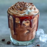 Rich chocolate syrup blends with cold brew coffee, topped with airy chocolate cream for a luxurious Chocolate Cream Cold Brew experience.