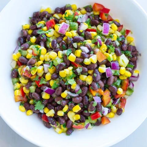 Fresh Cowboy Caviar Salad bursts with colorful vegetables and a zesty lime dressing, ready to eat.