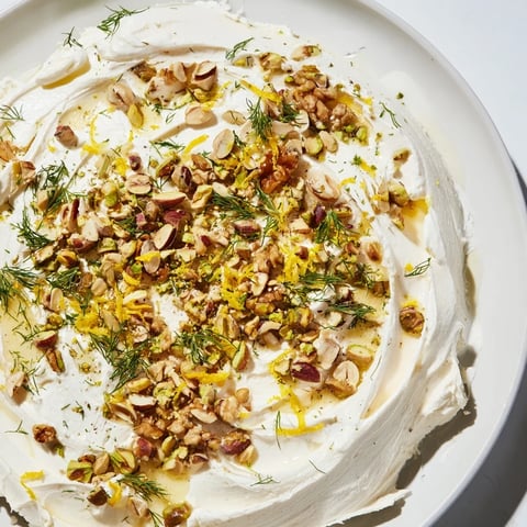 Creamy butter board charcuterie with toasted nuts, fresh herbs, and a sprinkle of sea salt.