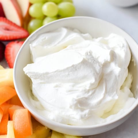 Sweet and fluffy, this cream cheese fruit dip beckons with fresh fruit for dipping.