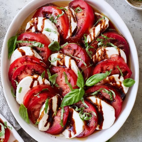 Bright, colorful slices of Sliced Tomatoes and Mozzarella Rounds awaiting your enjoyment, a simple Italian side.