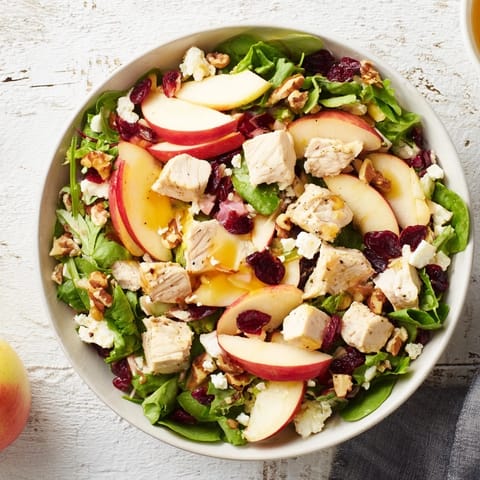 Delicious Chicken and Apple Winter Salad recipe, with vibrant colors and drizzled with tangy dressing, ready to eat.