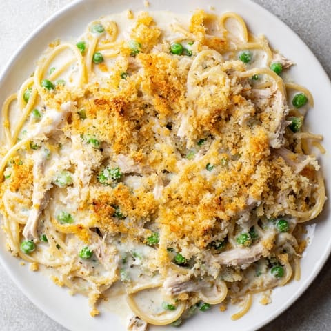 Enjoy a steaming bowl of Turkey Tetrazzini, a comforting casserole with melted cheese and pasta.