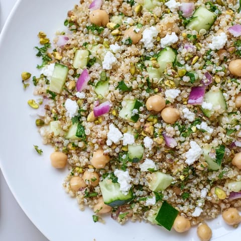 A healthy Jennifer Aniston Salad features bright quinoa, chickpeas, feta, and a zesty lemon dressing.