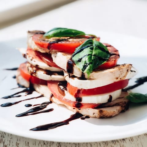 Fresh basil leaves and balsamic drizzle complete this colorful, easy Italian dinner salad.