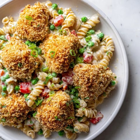A hearty bowl of Crispy Chicken Ranch Pasta Salad garnished with fresh dill, perfect for a satisfying lunch or picnic.
