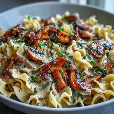 A skillet of Creamy Mushroom Stroganoff showcasing golden-brown mushrooms in a velvety sauce.