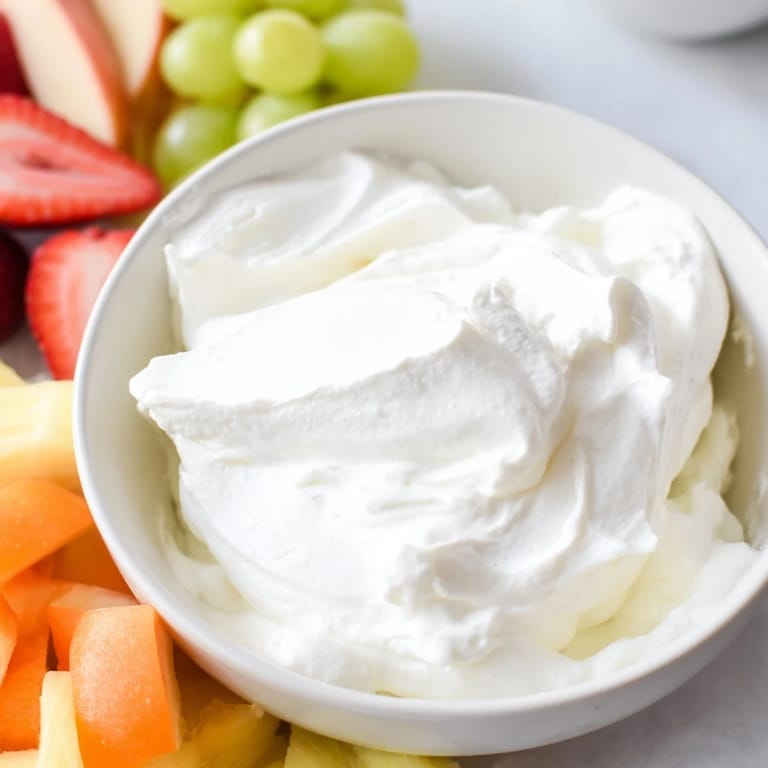 Sweet and fluffy, this cream cheese fruit dip beckons with fresh fruit for dipping.