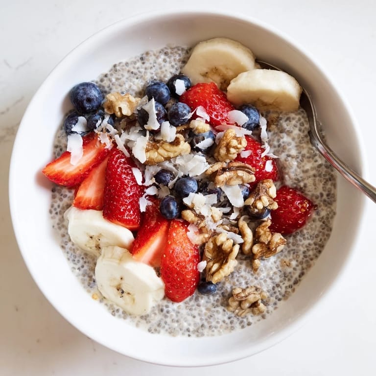 Stirred and chilled overnight, this creamy chia seed pudding is layered with mango and almonds, perfect for a vegan grab-and-go morning.