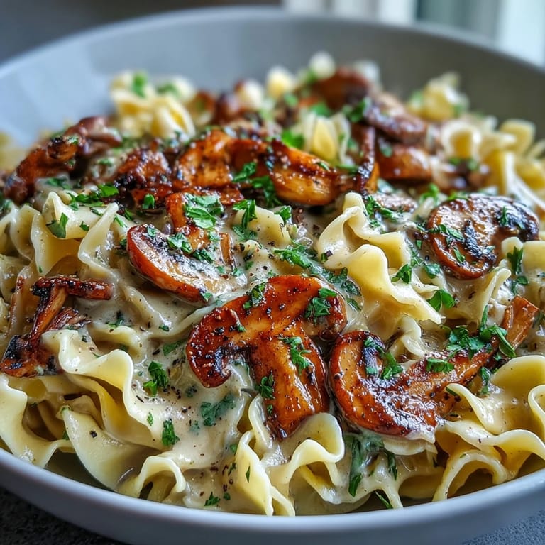 A skillet of Creamy Mushroom Stroganoff showcasing golden-brown mushrooms in a velvety sauce.