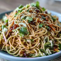 Asian Sesame Noodle Salad with Peanut Dressing featuring colorful vegetables and tender noodles in a creamy peanut sauce.