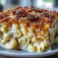 Creamy baked mac and cheese with golden panko topping, served hot from the oven as a comforting side dish.